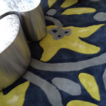 Kaja Gam Custom-designed furniture and rugs include stainless steel nested tables